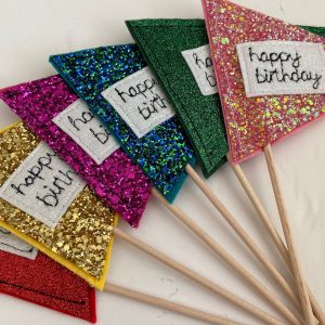Cute personalised, chunky glitter birthday flags/ cake toppers. They can be personalised with a name or short message if you'd like.